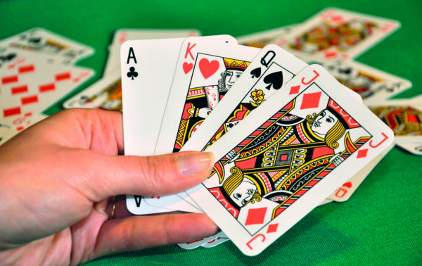 Playing,Cards,In,Women's,Hand,,Blur,Cards,In,Background