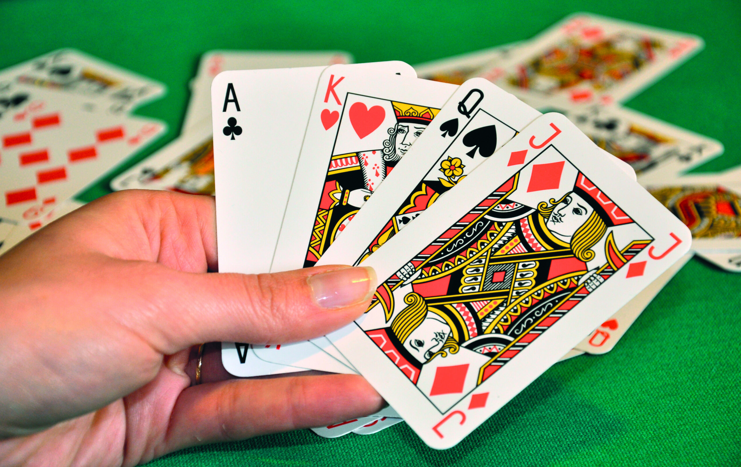 Playing,Cards,In,Women's,Hand,,Blur,Cards,In,Background